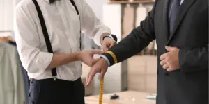 tailor taking measuremets.